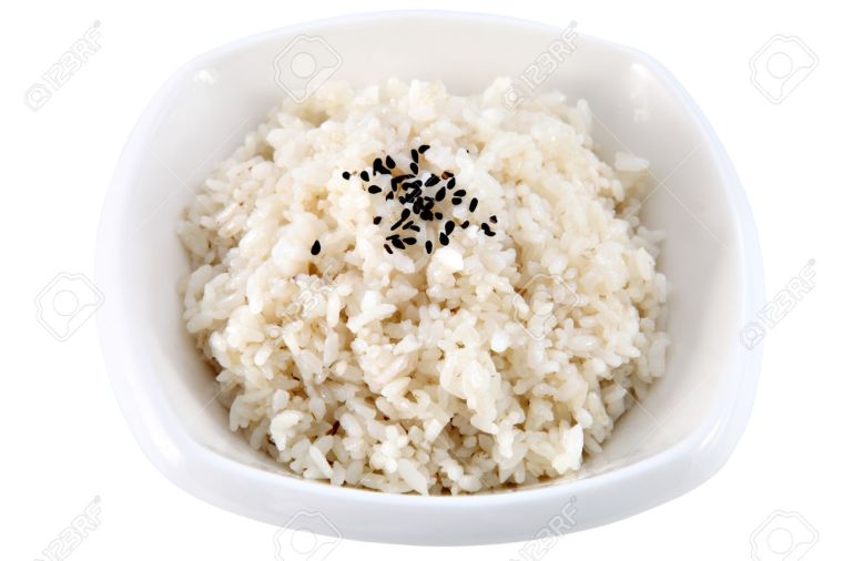 Asian cuisine, cooked rice in a deep dish, nothing but rice, isolated on a white background.